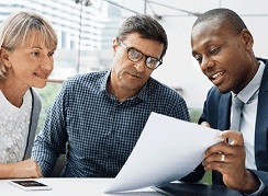 Confident rep meeting with clients. Errors and Omissions Insurance for Annuities and Mutual Funds Reps adds up